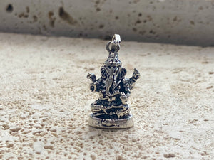 Sterling silver pendant featuring Lord Ganesha portrayed in 3D, this heavy silver charm pendant can be viewed in 3 dimensions, with his back as complete and as detailed as his front. A generous bail allows this pendant to be worn on a large chain or cord. he can even sit upright as the smallest of ganesh statues. This is a unisex pendant or statue. Sterling silver. Measurements: 3 cm height including bail