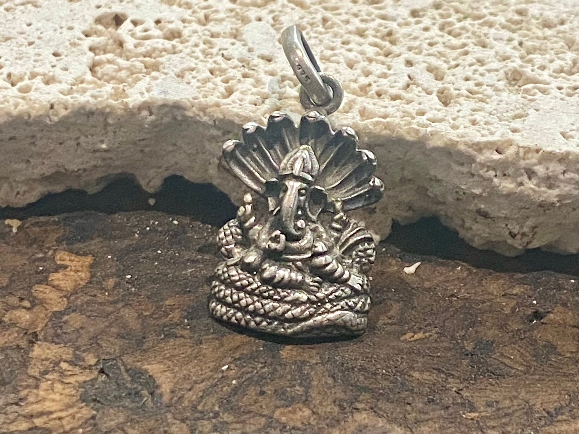 Detailed sterling silver pendant featuring Lord Ganesha cast in exquisite detail. A generous bail allows this pendant to be worn on a large chain or cord. This is a unisex pendant. Sterling silver, from India Measurements: 1.8 cm height including bail, width 1.2 cm