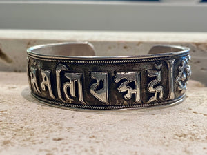 Sterling silver Buddhist Om Manu Padme Hum bracelet. This is a large and substantial men's silver cuff  This beloved Buddhist mantra translates to “hail, jewel in the lotus” and is the prayer of the Compassionate Buddha Avelokitsvara.