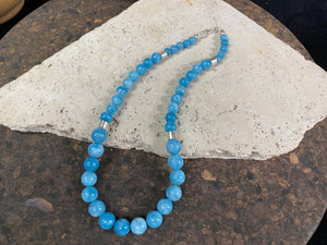 Graduated blue chalcedony necklace with sterling silver bead detailing and a sterling silver hook clasp. Measurements: 41.5 length including hook, diameter of beads 8, 6 and 4 mm