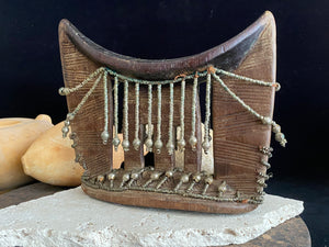 Kambatta wood headrest, Ethiopia. Early 1900's. Heavily carved and beaded. Dark patina and smooth wear on this piece are appropriate to its age. Measurements: height 16 cm (7"), width 18 cm