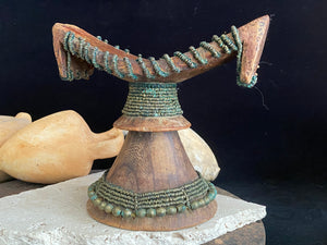 Very old Oromo wooden headrest from Ethiopia. Carved from a single piece of wood, heavily beaded with green oxidation. Pre 1950. The patina and wear on this piece are appropriate to its age.  Measurements: height 16 cm, width 18 cm