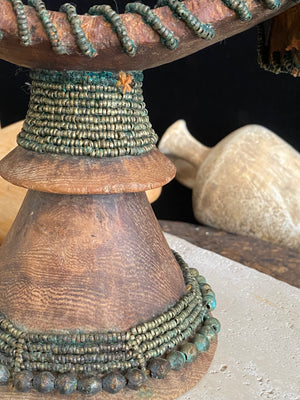 Very old Oromo wooden headrest from Ethiopia. Carved from a single piece of wood, heavily beaded with green oxidation. Pre 1950. The patina and wear on this piece are appropriate to its age.  Measurements: height 16 cm, width 18 cm