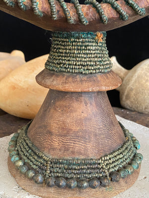 Very old Oromo wooden headrest from Ethiopia. Carved from a single piece of wood, heavily beaded with green oxidation. Pre 1950. The patina and wear on this piece are appropriate to its age.  Measurements: height 16 cm, width 18 cm