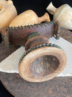 Very old Oromo wooden headrest from Ethiopia. Carved from a single piece of wood, heavily beaded with green oxidation. Pre 1950. The patina and wear on this piece are appropriate to its age.  Measurements: height 16 cm, width 18 cm