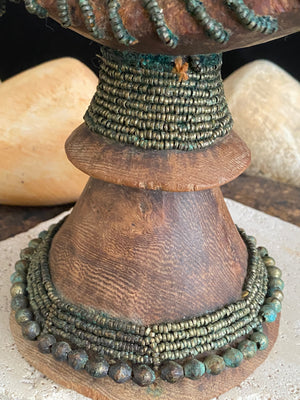 Very old Oromo wooden headrest from Ethiopia. Carved from a single piece of wood, heavily beaded with green oxidation. Pre 1950. The patina and wear on this piece are appropriate to its age.  Measurements: height 16 cm, width 18 cm