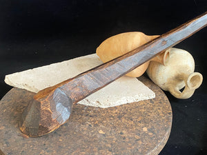 Vintage wood serving ladle. Hand carved wood. From northern India. This spoon is drilled and can be hung from its leather strap. This spoon has a lovely worn patina commensurate with its age. Each piece is hand carved, unique and artisan made. Length 58 cm, width of spoon 8 cm.