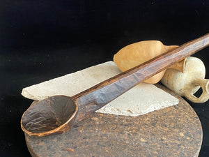 Vintage wood serving ladle. Hand carved wood. From northern India. This spoon is drilled and can be hung from its leather strap. This spoon has a lovely worn patina commensurate with its age. Each piece is hand carved, unique and artisan made. Length 58 cm, width of spoon 8 cm.
