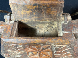 These oddly shaped pots were used to store mustard oil, ghee, yak butter and lantern oil. This very heavy example weighs 2.4 kg and is carved from solid teak. Hand beaten iron hinges. Traces of oil encrustation still inside. Age 1900-1920 or earlier. Measurements: width 29 cm, depth 12 cm, height 13.5 cm