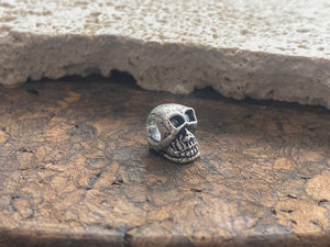 Sterling silver skull charm or pendant. Length 1 cm
