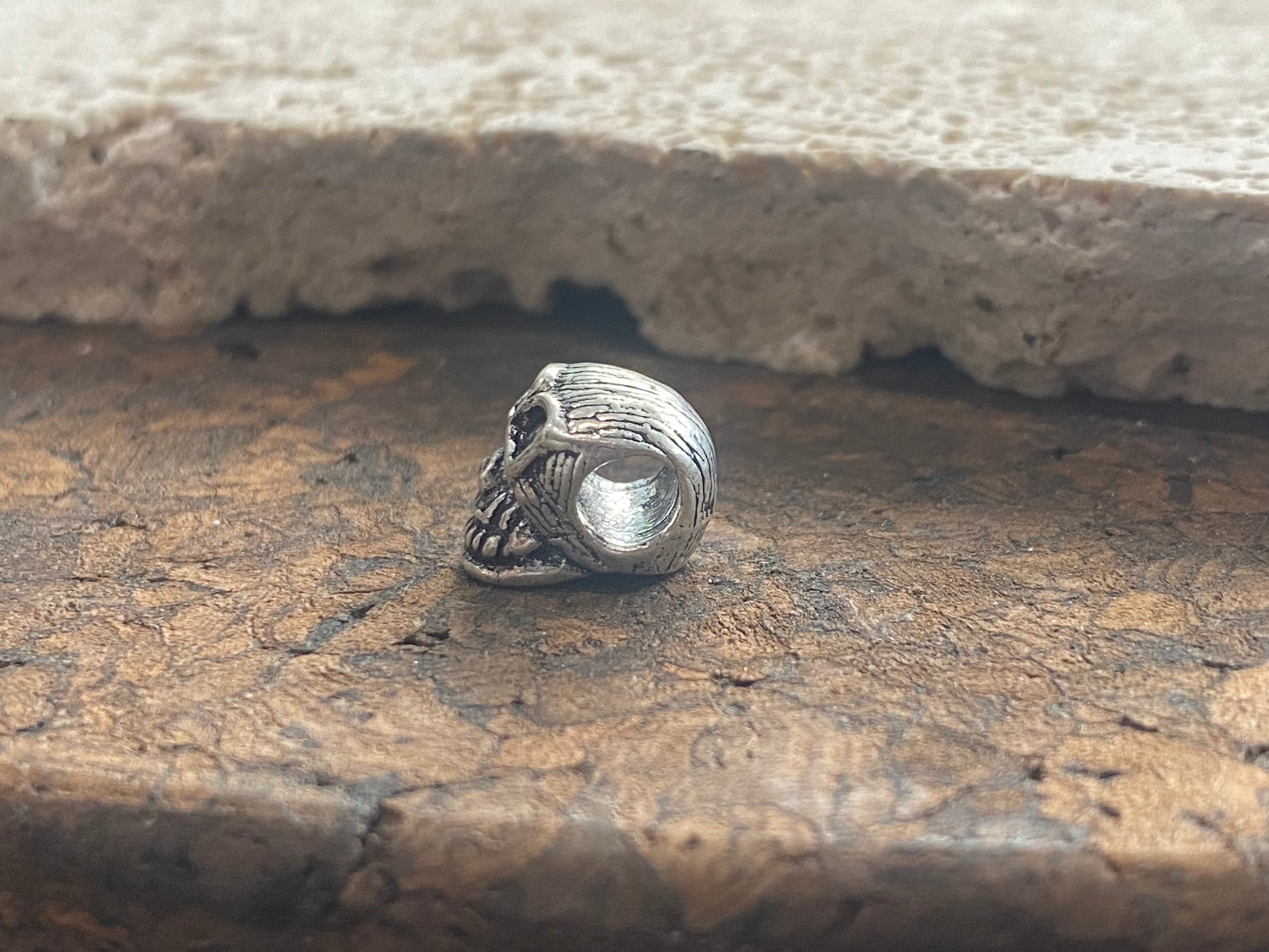 Sterling silver skull charm or pendant. Length 1 cm