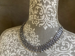 A classic Rajasthani style Indian necklace in white metal (non silver). Flattering to any neckline, it can be worn as a choker or a longer necklace by fastening the chain length to suit. It also be worn as an anklet by removing the chain altogether.  Beautiful without the sterling silver price tag. Measurements: 47.2 cm length with chain. Without chain 25.5 cm.