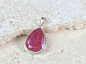 Natural ruby pendants featuring large facet cut stones set in sterling silver. All are set with generous bails to fit on even the largest of chains, torcs or cords. Ranging in length from 6 cm to 2.5 cm