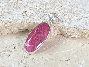 Natural ruby pendants featuring large facet cut stones set in sterling silver. All are set with generous bails to fit on even the largest of chains, torcs or cords. Ranging in length from 6 cm to 2.5 cm