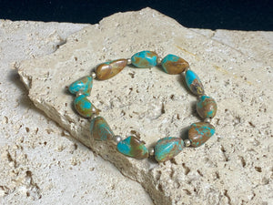 Natural Tibetan turquoise bracelet finished with sterling silver beads. Strong on sturdy elastic for a seamless look. Measurements: length 19 cm (7.5")
