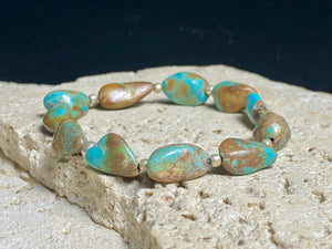 Natural Tibetan turquoise bracelet finished with sterling silver beads. Strong on sturdy elastic for a seamless look. Measurements: length 19 cm (7.5")