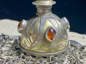 Tekke Turkoman women's cap jewellery.  High grade silver, 24k gold fire gilding, finished with four carnelian stones.All dangles are intact. Mid 20th Century. This would have once endowed the headdress of a Turkoman girl. Measurements: total height including dangles 18 cm (6.5"). Diameter at base 5 cm (1.5"). Height of body (without dangles) 8.5 cm