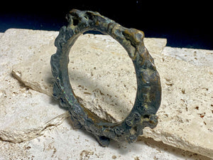 Antique Bronze Dông Son bracelet, Vietnam. Solid cast bronze bangle featuring an array of animals. Inside diameter 25 cm. Height 1.3 cm.