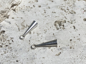Strong and long elegant silver cone ends. Perfect for finishing multi strand necklaces. Long enough to hold single tapered stones with absolute confidence. Lght enough to be incorporated into earring projects.Sterling silver. Length 2.2 cm