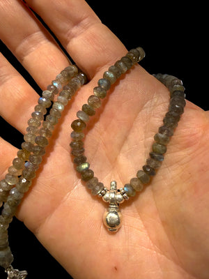 Faceted labradorite rondels, sterling silver detailing and a solid silver pendant, sterling silver hook clasp. Length: 44 cm