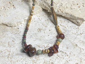 A unique necklace featuring bloodstone, jasper, Baltic amber and antique amber prayer beads. Highlighted with sterling silver beads and ends. Length 69 cm