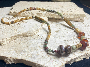 A unique necklace featuring bloodstone, jasper, Baltic amber and antique amber prayer beads. Highlighted with sterling silver beads and ends. Length 69 cm