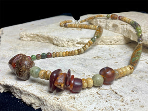 A unique necklace featuring bloodstone, jasper, Baltic amber and antique amber prayer beads. Highlighted with sterling silver beads and ends. Length 69 cm