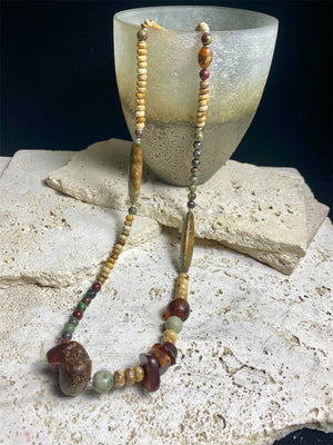 A unique necklace featuring bloodstone, jasper, Baltic amber and antique amber prayer beads. Highlighted with sterling silver beads and ends. Length 69 cm