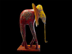 Our biggest and brightest elephant statue. Hand carved from solid hard wood with a recycled iron trunk, ears, tusks and trunk, full of gorgeous character and painted in intricate embossed detail.  Measurements: height 48.5 cm, length 32 cm, depth 12 cm