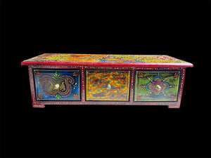 This intricately painted box features three spacious drawers, small feet and brass knobs as handles. The roominess of the drawers means our long, low chest is perfect for holding everything from trinkets to jewellery and essential oils. Width 34.5, depth 13 cm, height 10.5 cm