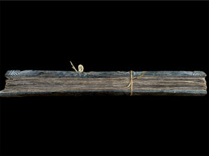 Sinhalese palm (ola) leaf book, ca. early 20th century CE. South Asia. Religious text from a Hindu-Buddhist monastery. Contains 60 leaves bound by two cords between a pair of wood slat covers. Measurements: Length 56 cm (22") x height 7.5 cm (3") x width 4.5 cm (1.75")