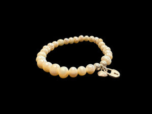 Freshwater pearl bracelet with sterling silver bead & charm detailing. Elasticised stringing for a seamless look.
Measurements: wrist circumference 16 - 17 cm.