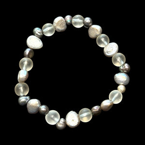 A delightful bracelet of irregular silver and dark grey freshwater pearls, rock crystal beads and sterling silver. Elasticised stringing for a seamless look.
