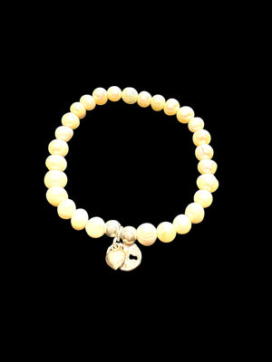 Freshwater pearl bracelet with sterling silver bead & charm detailing. Elasticised stringing for a seamless look.
Measurements: wrist circumference 16 - 17 cm.