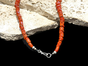 Necklace of graduated antique red coral from the Himalayas, finished with an antique silver bead and sterling silver clasp. Length 42.5 cm