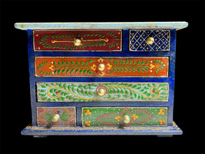 Hand painted chest of drawers features six drawers of varying sizes. Petite feet and polished brass knobs as handles. Small and compact, it is an ideal choice for storing a variety of items. Width 24 cm, depth 10 cm, height 17.5 cm