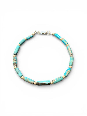Turquoise bracelet of tube-cut, sky blue natural turquoise beads, with sterling silver detailing and clasp. Order in different sizes.