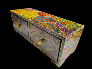This intricately painted box features two spacious drawers, small feet and brass knobs as handles. The roominess of the drawers means our long, low chest is perfect for holding everything from trinkets to jewellery and keys. A lovely, hand painted piece of craftsmanship from Rajasthan, India.
Measurements: width 24, depth 9 cm, height 9 cm