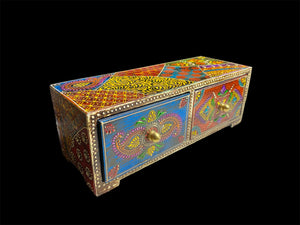 This intricately painted box features two spacious drawers, small feet and brass knobs as handles. The roominess of the drawers means our long, low chest is perfect for holding everything from trinkets to jewellery and keys. A lovely, hand painted piece of craftsmanship from Rajasthan, India.
Measurements: width 24, depth 9 cm, height 9 cm