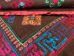 Yathra weaving, from the Chumey Valley in Bumthang, Bhutan. Hand spun and natural dyed yarn is backstrap woven into wool panels, then embroidered with wool thread. Mid 20th century. This textile is called a denkeb and was likely used as a rain cloak. Its condition is commensurate with its age. Measurements: 173 x 84 cm