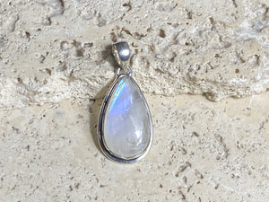 Teardrop high cut rainbow moonstone pendant set in lovely southwest style sterling silver surround with a generous bail to take a large chain or cord. A lovely stone with blue fire.   Measurements: Length including bail 4 cm, width at widest point 2 cm
