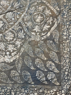 Pichwai temple hanging, silver leaf on a ground of handwoven cotton, featuring Krishna, gopis and apsaras. This devotional cloth hanging was made by Shri Nathji devotees of the Pushti Marg Sect. A large and rare circular-patterned example dating to late 19th Century and a collector's item. Measurements: 173 x 157 cm.