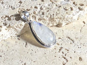 Teardrop high cut rainbow moonstone pendant set in lovely southwest style sterling silver surround with a generous bail to take a large chain or cord. A lovely stone with blue fire.   Measurements: Length including bail 4 cm, width at widest point 2 cm