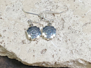 Cross earrings with a southwest vibe. The body of the earring is made from a non-tarnishing white metal indistinguishable from silver, while the other parts and hooks are sterling silver. Lightweight and easy to wear, the pattern on the earring is repeated on both sides. Measurements: drop including hook 2.5 cm