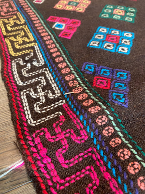 Yathra weaving, from the Chumey Valley in Bumthang, Bhutan. Hand spun and natural dyed yarn is backstrap woven into wool panels, then embroidered with wool thread. Mid 20th century. This textile is called a denkeb and was likely used as a rain cloak. Its condition is commensurate with its age. Measurements: 173 x 84 cm