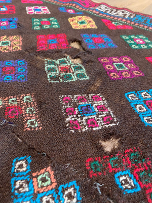 Yathra weaving, from the Chumey Valley in Bumthang, Bhutan. Hand spun and natural dyed yarn is backstrap woven into wool panels, then embroidered with wool thread. Mid 20th century. This textile is called a denkeb and was likely used as a rain cloak. Its condition is commensurate with its age. Measurements: 173 x 84 cm