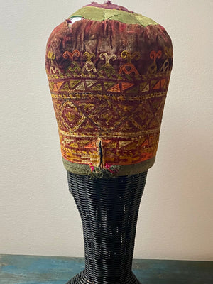 Ersari headdress consisting of a metal gaashbaagh & a high embroidered conical hat into which it attached with long spikes. The cap is quilted cotton covered in velvet and detailed silk embroidery. An heirloom piece, dating from 1870-1890. Cap height 23 cm. Tiara: width 53 cm, height of band 7 cm, side dangles 44 cm