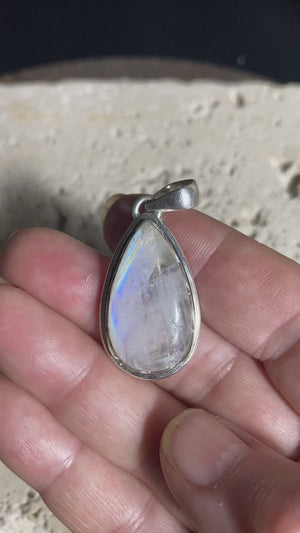 Teardrop high cut rainbow moonstone pendant set in lovely southwest style sterling silver surround with a generous bail to take a large chain or cord. A lovely stone with blue fire.   Measurements: Length including bail 4 cm, width at widest point 2 cm