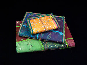 Eco-friendly sari cover journal notebooks are filled with creamy white, handmade recycled notebook paper and are covered in a patchwork of old cotton sari textiles, all finished with cotton, thread and sequin detailing. Three sizes