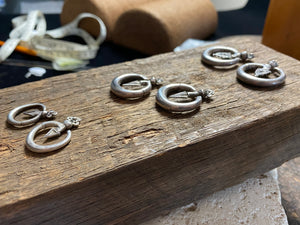 Three pairs of tribal silver earrings called Bent Arrow. Worn pushed sideways through the ear by Yao women. High grade silver, they can only be worn with an extended piercing